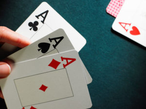 Person with handful of cards mid-game