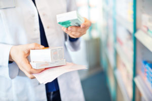 Pharmacist holding prescriptions