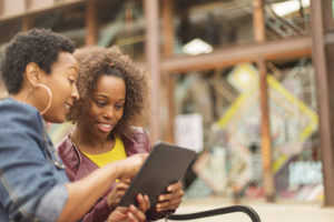 Two woman shopping on a tablet