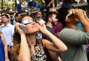 People watching 2017 eclipse on New York street