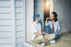 Shot of a couple looking intensely at each other sitting together
