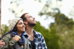 Couple stands for a moment while talking walk outside to enjoy nature
