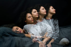 Multiple exposure photo depicts person with long curly hair rising from bed while still asleep