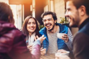 Two couples drinking coffee and chatting