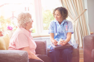 Doctor or other care provider visits older adult at home
