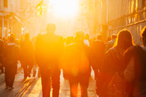 Crowd on street in bright lens flare