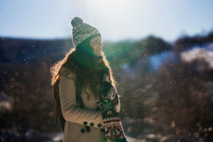 Woman enjoying snow on a sunny, clear day