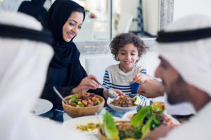 A family enjoys a lunch of salad and mezze. 