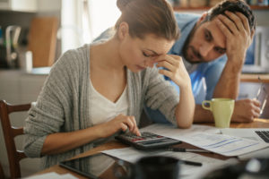 Two partners together at table both looking stressed