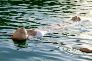 Woman floating on her back in water