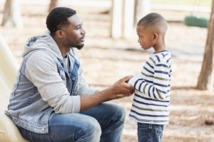 Man talks to son on playground