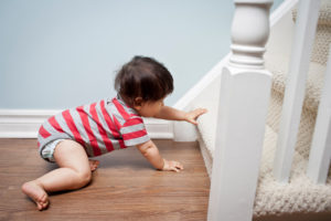 Baby trying to crawl and climb the staircase