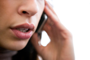 Close up of young woman speaking over phone