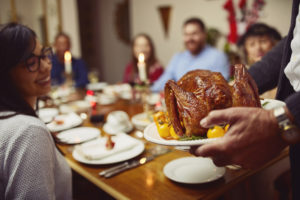 Closeup shot of a turkey being served during a feast at a dining table