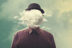 Surreal photo of person in bowler hat with cloud in place of head