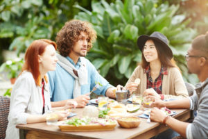 Group of 4 nonmonogamous young adults eating brunch