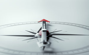 Compass on white background with selective focus. 