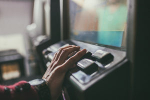 Close-up of hand resting on slot machine