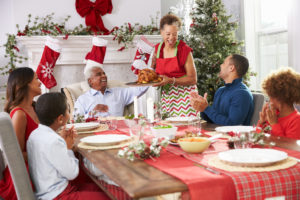 Woman brings out a turkey for her family's Christmas Day feast