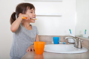 Cute girl brushing teeth