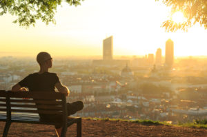 A man observes the city at dawn