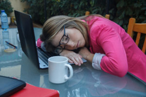 Young businesswoman falls asleep while working.