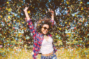 Lady smiling in a storm of confetti