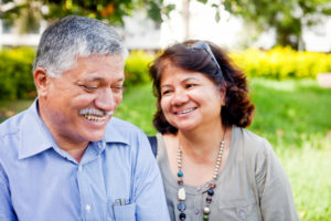 A mature woman looks lovingly at her husband.