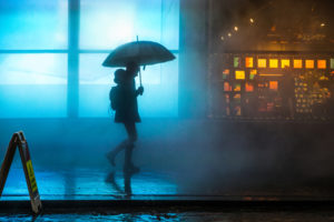 A person walks home alone in the rain