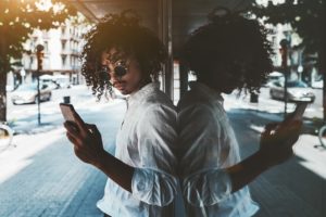 Man stares arrogantly at camera, holding his phone