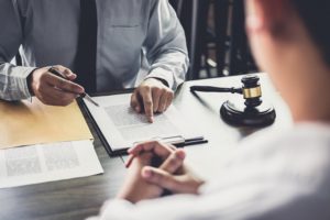 Lawyer sits across the desk with a client, explaining a court order