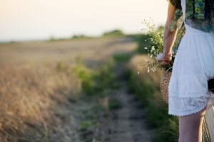 Woman biking through field