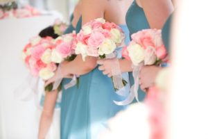 Many bridesmaids holding flowers
