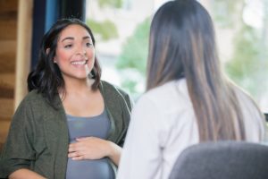 Pregnant woman talking with her care provider