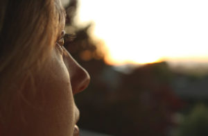 Closeup on face of woman, staring out into the distance