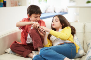 Siblings argue over TV remote