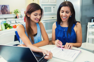 Mother and daughter read permission slip together.
