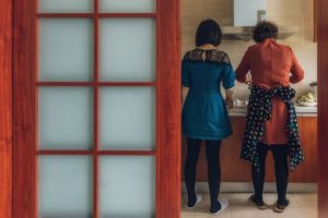 Adult daughter cooking with her mother