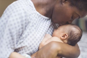 New mom holds infant to her chest