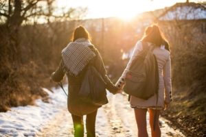 Girlfriends holding hands on a walk
