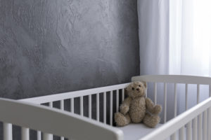 teddy bear in gloomy crib