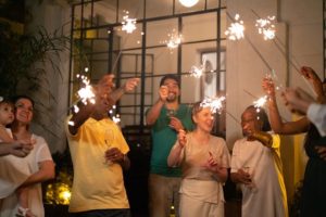 Gathering of family members celebrating a holiday with sparklers
