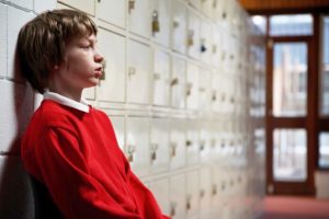 Child standing by lockers