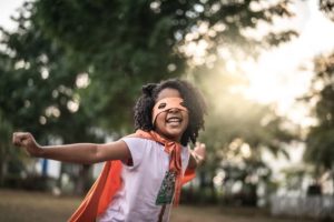 Girl playing in superhero costume