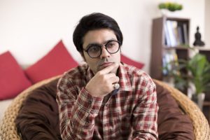 Man sitting and staring into the distance thoughtfully