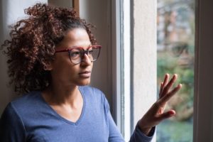 Woman looking thoughtfully out a window