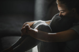 Young woman feeling depressed at home.