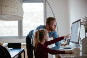 Daughter and father using a computer