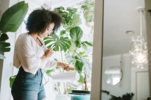Woman watering her indoor plants