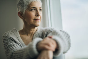 Mature woman gazing out the window